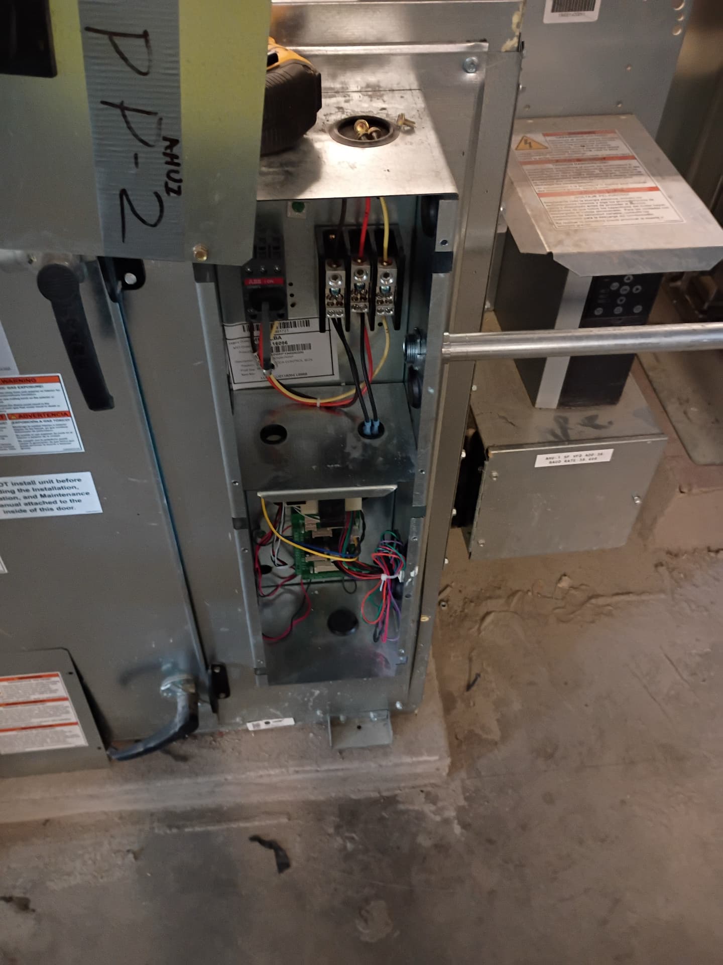 Open air-handler electrical compartment with ABB breaker and VFD control wiring