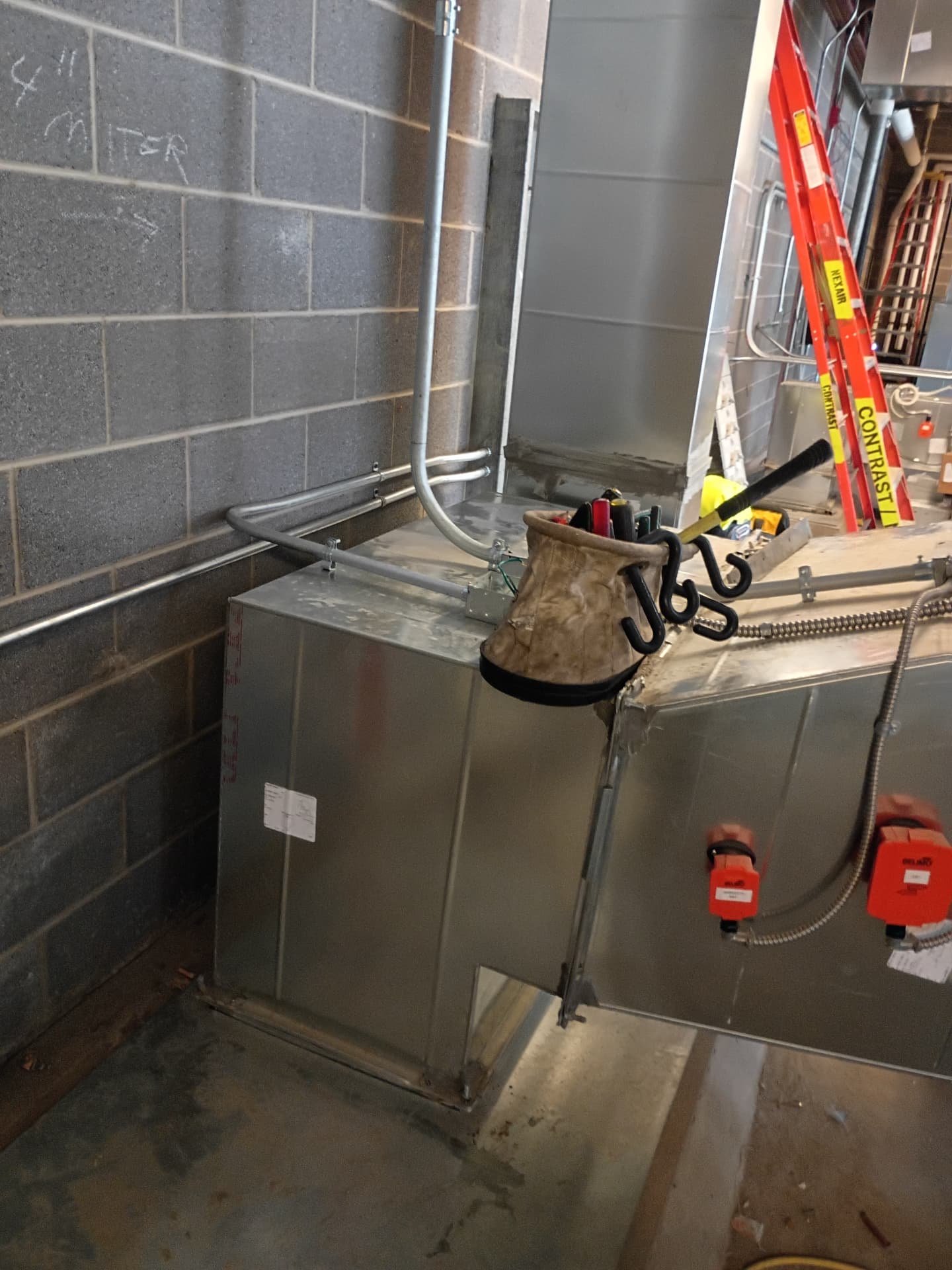 EMT conduit run to a junction box on an HVAC duct with red actuators at a Novi school
