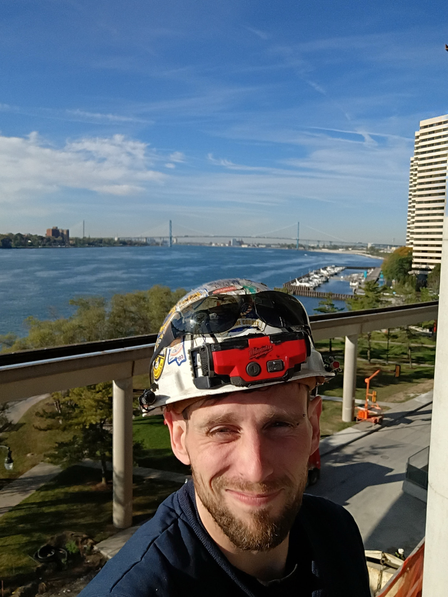 Electrician at the Marriott building overlooking the Detroit River and Ambassador Bridge